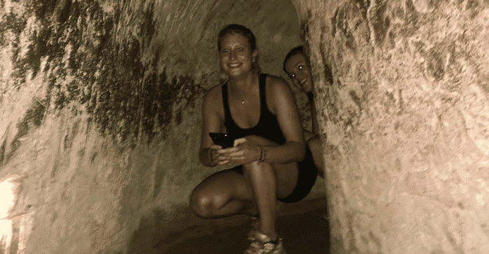 woman crouching in tunnel