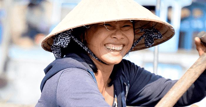 woman smiling in conical hat