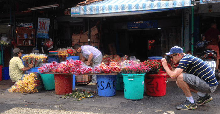 man taking flowers of flower market