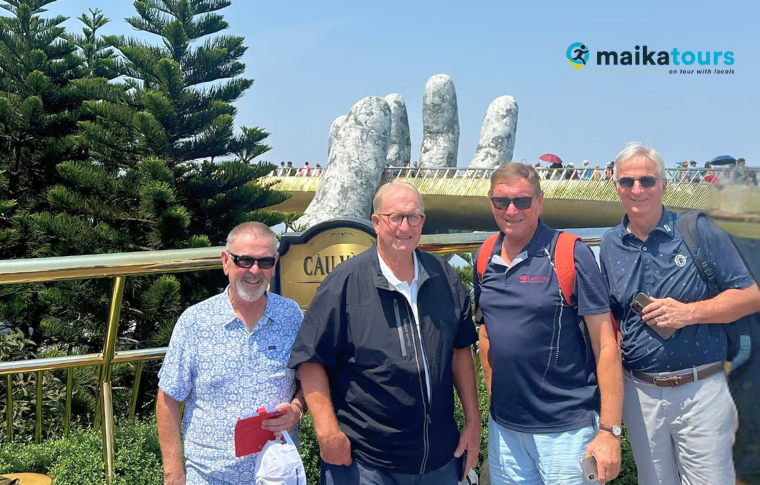 a group of tourists standing at the Golden Bridge