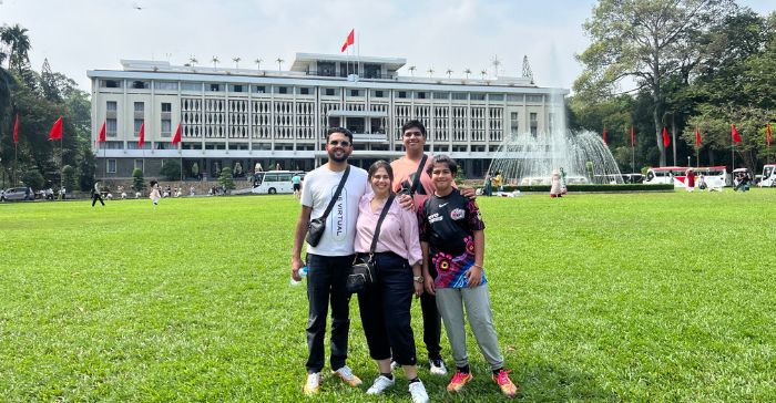 a group of tourists standing in front of a palace