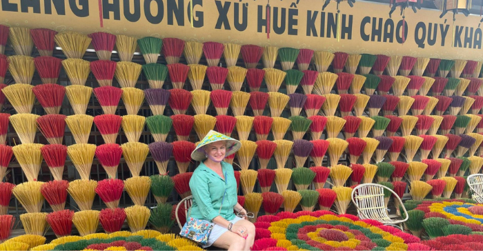 a woman sitting among incense sticks 