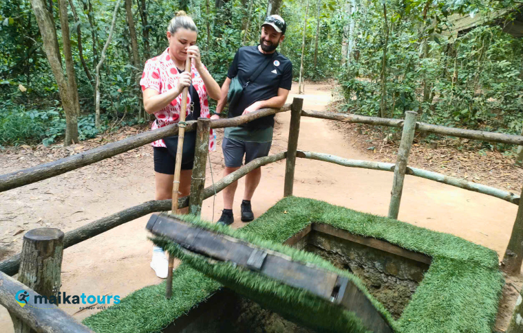 two tourists standing next to a trap