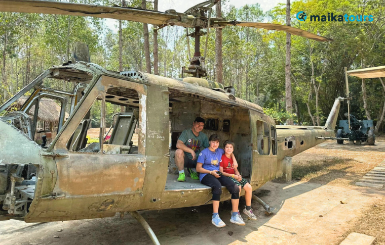 a family on a ruined helicopter